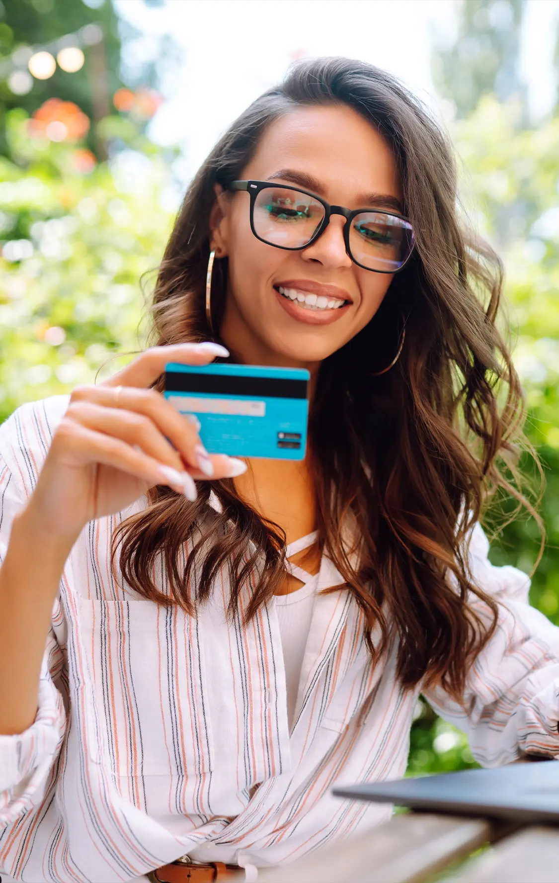 A woman holding a credit card